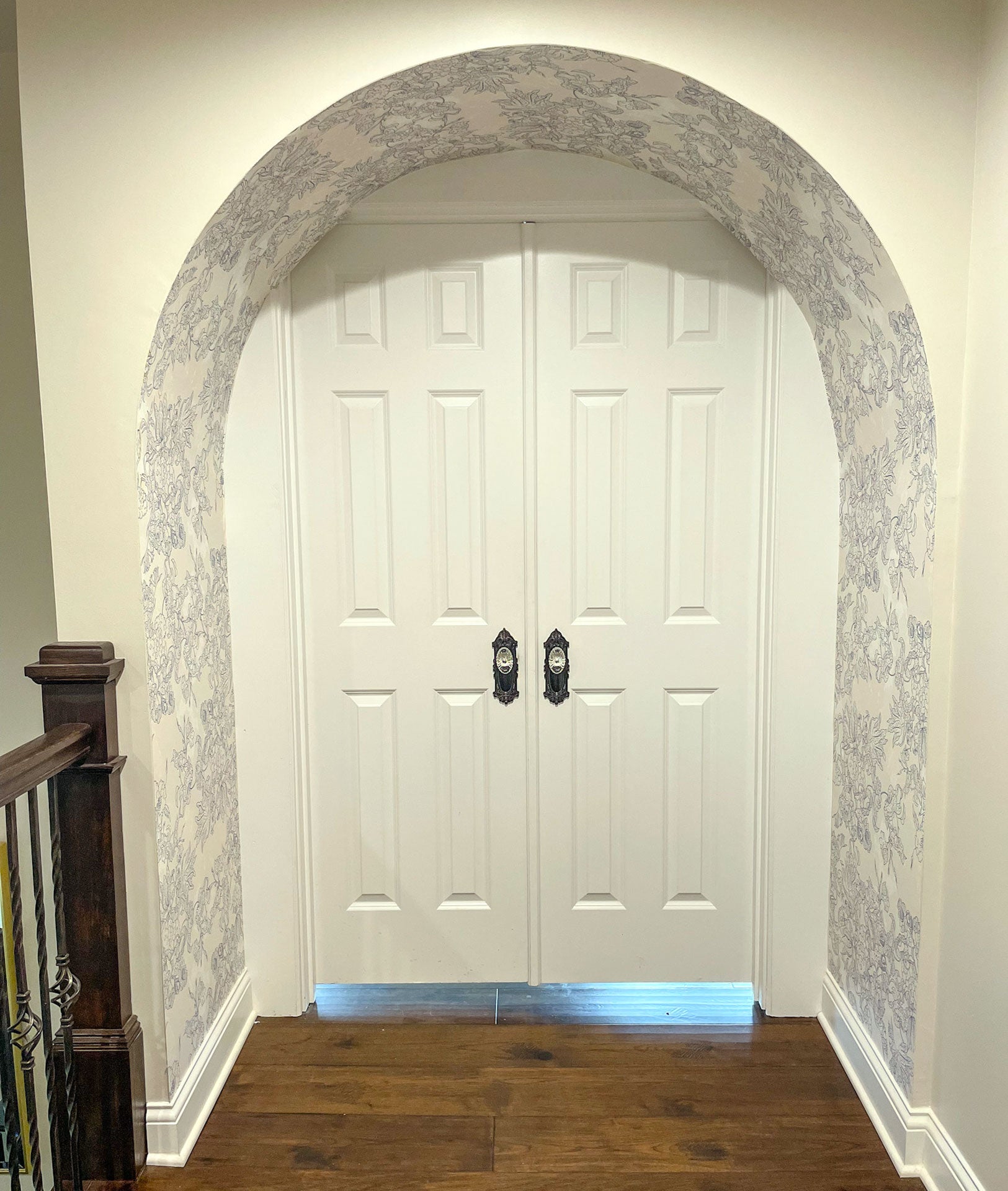 french doors with arched entry and vintage bronze hardware